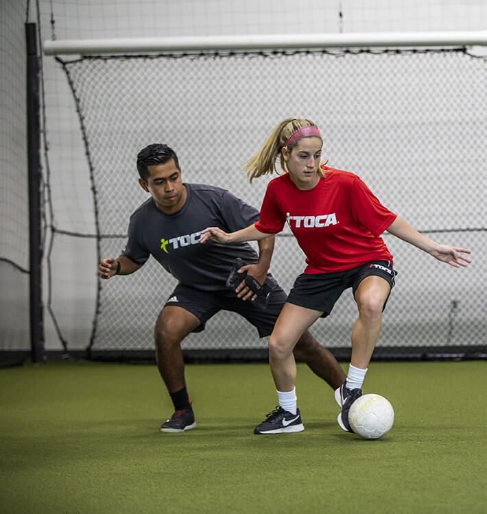 Soccer player takes touch away from defender