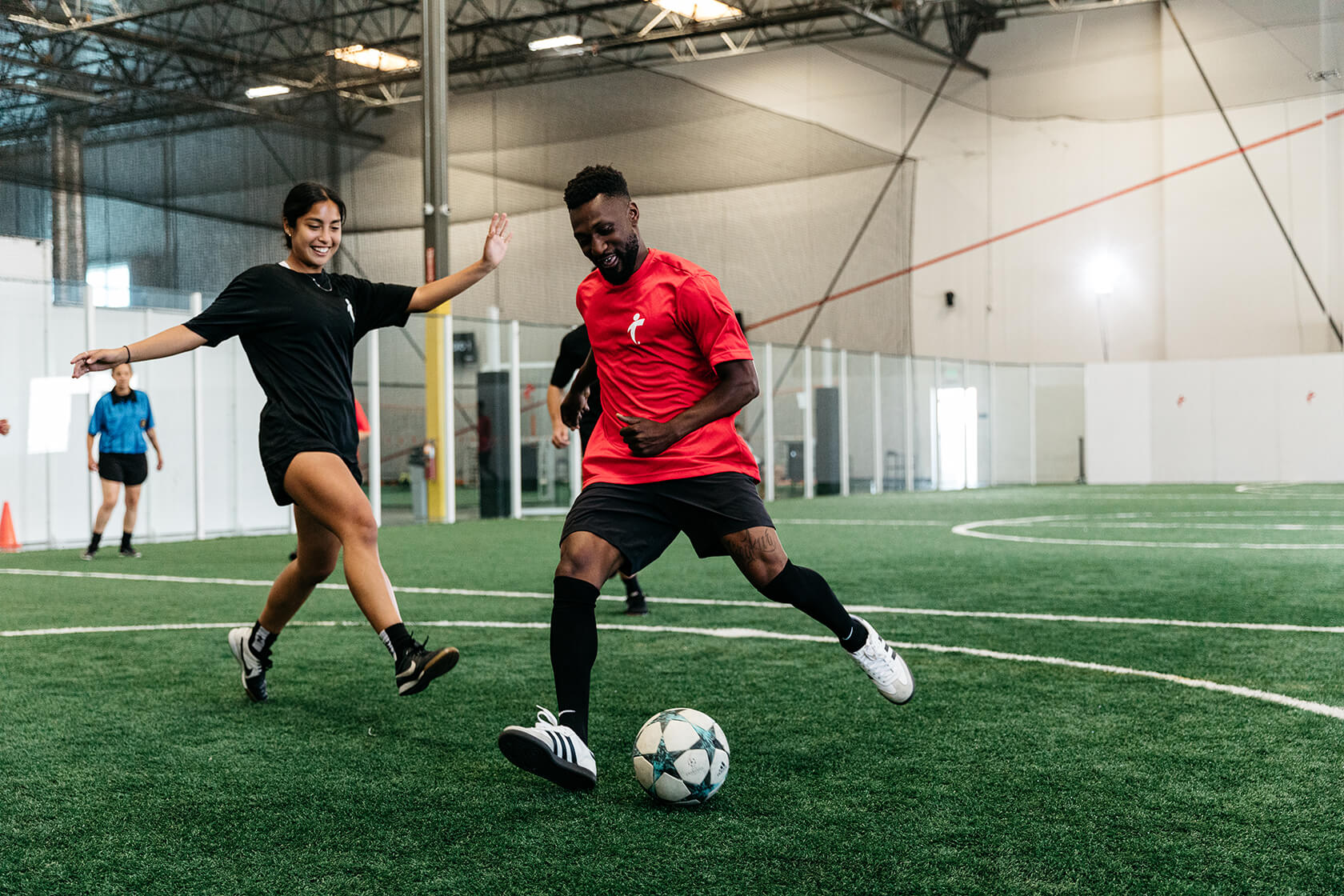 Woman and man playing soccer